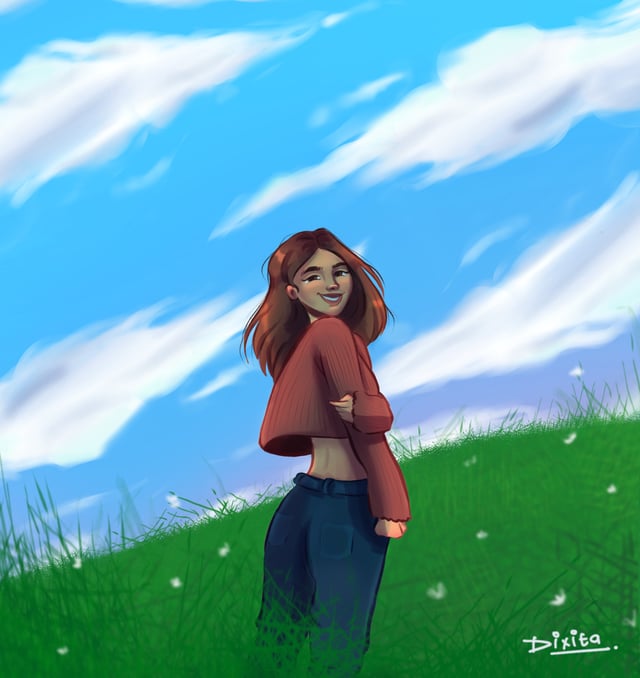 Young woman looking over her shoulder in a green field beneath a bright blue sky.